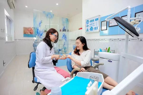 Chuyên viên tư vấn cho khách hàng trong phòng chăm sóc da có thiết bị soi da.